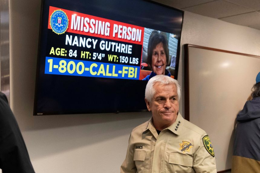 Pima County Sheriff Chris Nanos exits the press room past a missing persons poster after giving an update on the investigation after the disappearance of Nancy Guthrie in February 2026.